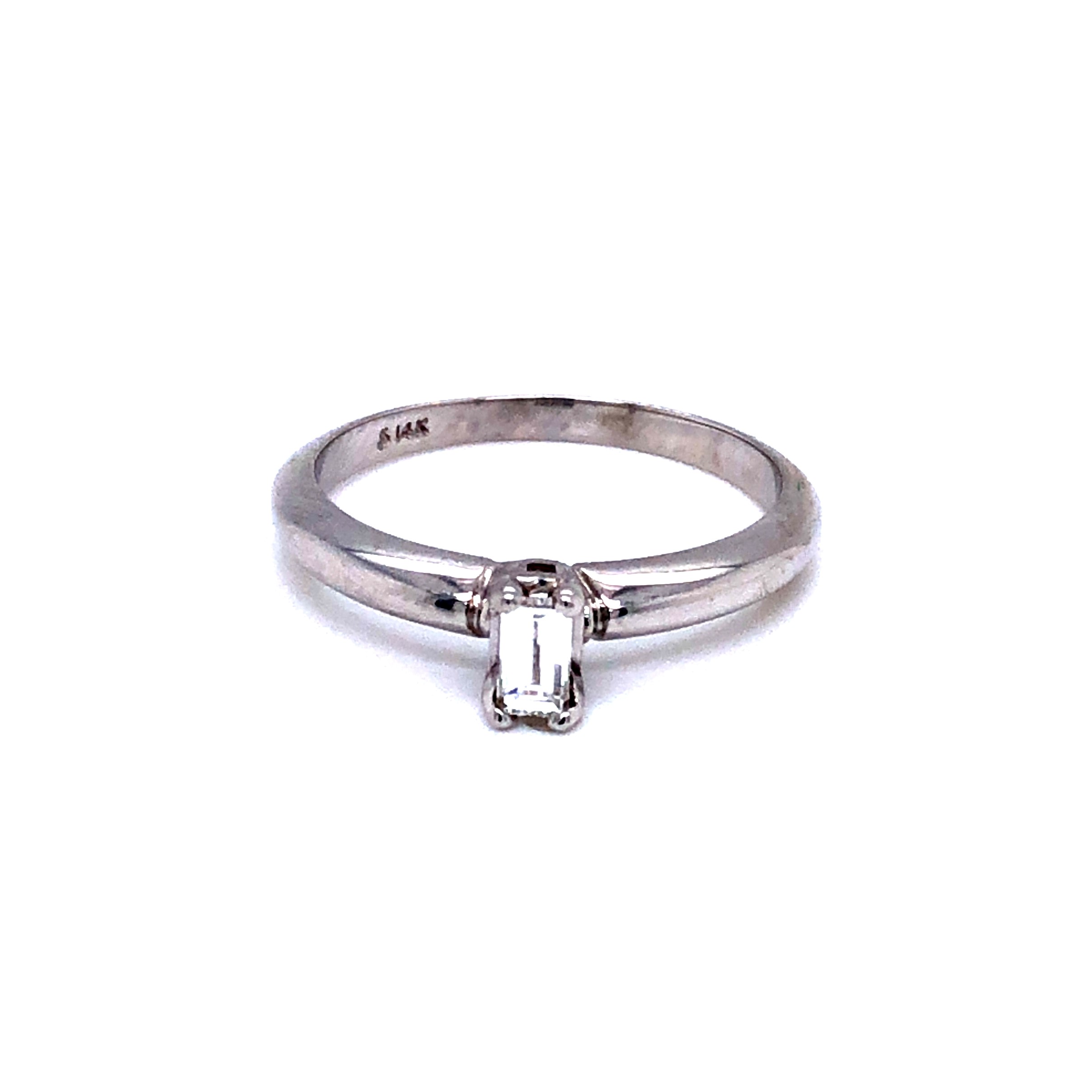 Lady s 14 karat white gold solitaire engagement ring with an Emerald cut diamond weighing 0.18 carat  F color  VS1 clarity.