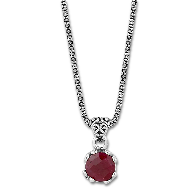Sterling silver round ruby pendant on a popcorn chain.
