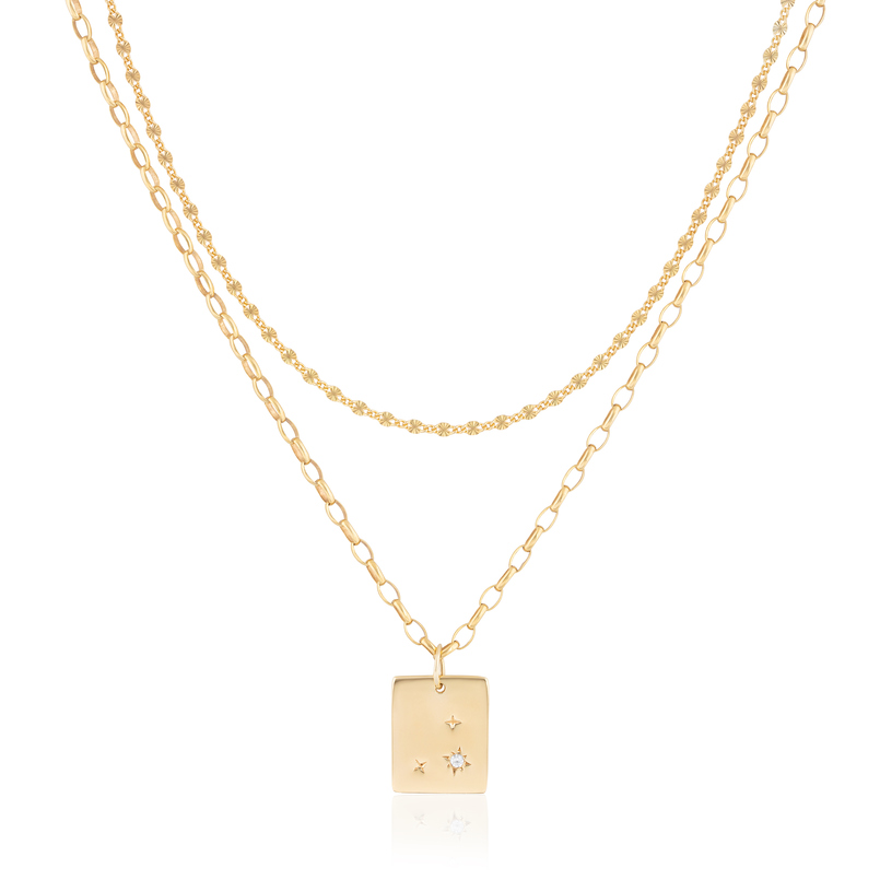 Sterling silver plated in 14 karat yellow gold starburst dog tag with white zircon on a 14" chain.