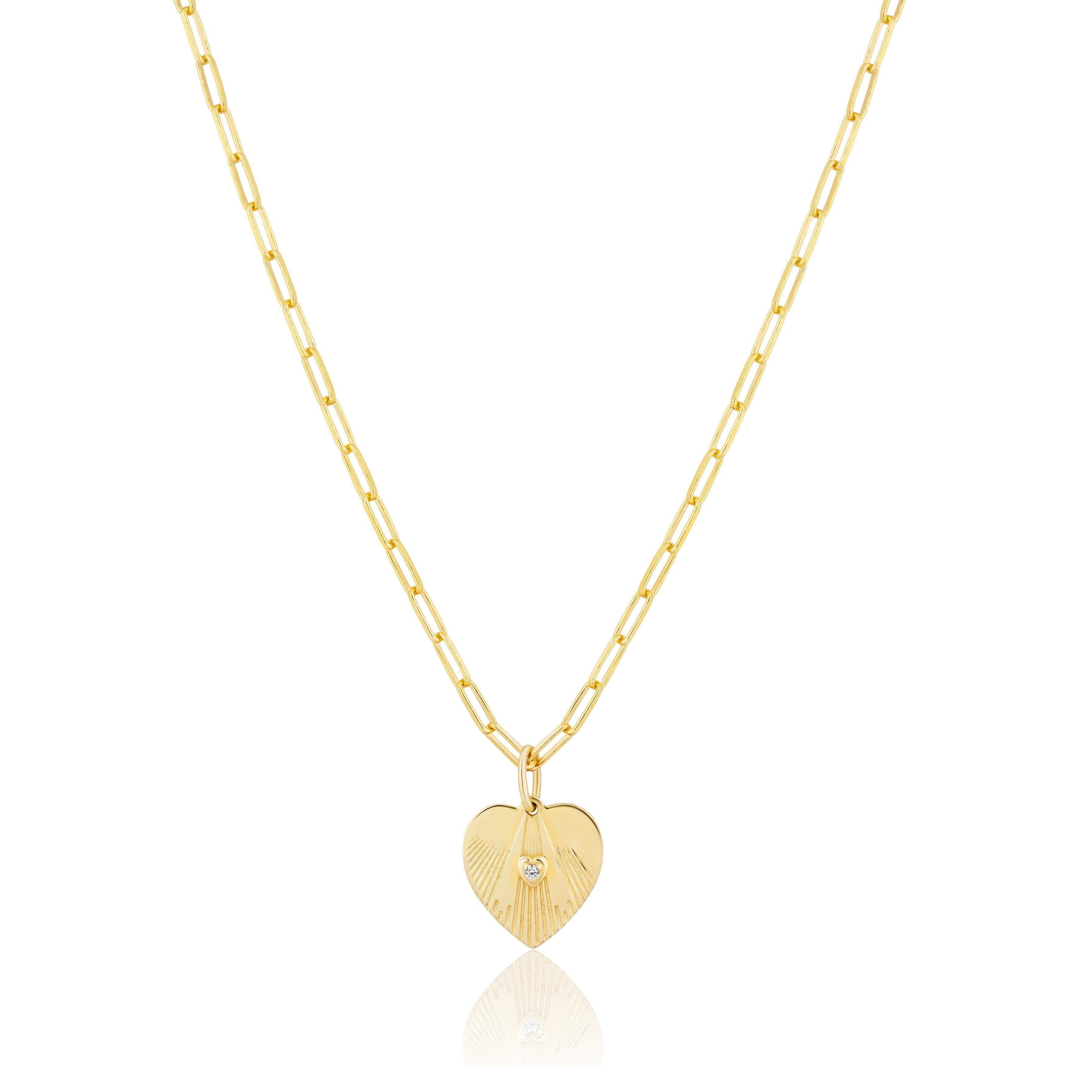 Sterling silver plated in 14 karat yellow gold mini heart charm with white zircon on a paperclip chain.