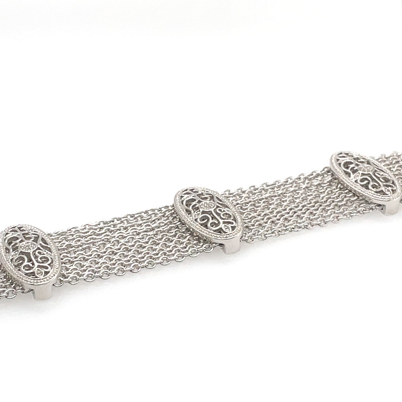 36 ROUND DIAMOND; TRIPLE OVAL FILIGREE STATIONS; 12-CHAIN BRACELET; .11CTW; SILVER/STAINLESS STEEL