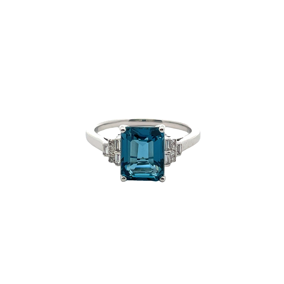 EFFY LONDON BLUE TOPAZ + DIAMOND "3-STONE" RING CONTAINING: 3.10CT EMERALD CUT LONDON BLUE TOPAZ CENTER; + 8 ROUND AND 6 BAGUETTE DIAMONDS; .11TDW; 14KW