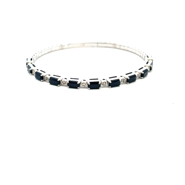 4.15TGW SAPPHIRE + DIAMOND SOFT BANGLE BRACELET CONTAINING: 11 EMERALD CUT BLUE SAPPHIRES; 3.85CTW; + 10 ROUND BEZEL-SET DIAMONDS; .30TDW; 14KW