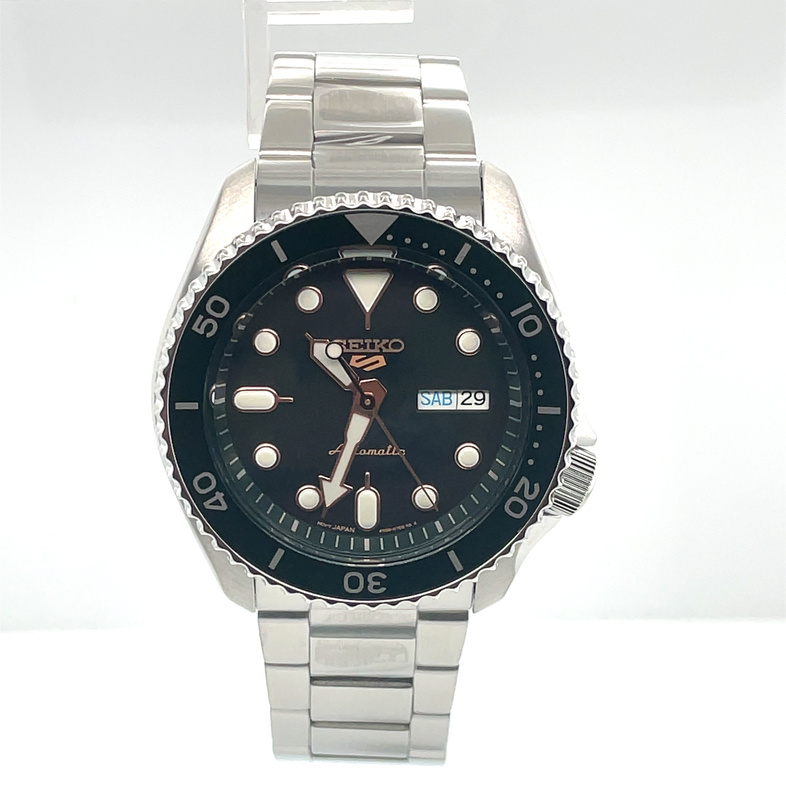 SEIKO 42.5MM BLACK DIAL WITH ROSE GOLD ACCENTS; GREEN BEZEL; LINK BRACELET; STAINLESS
